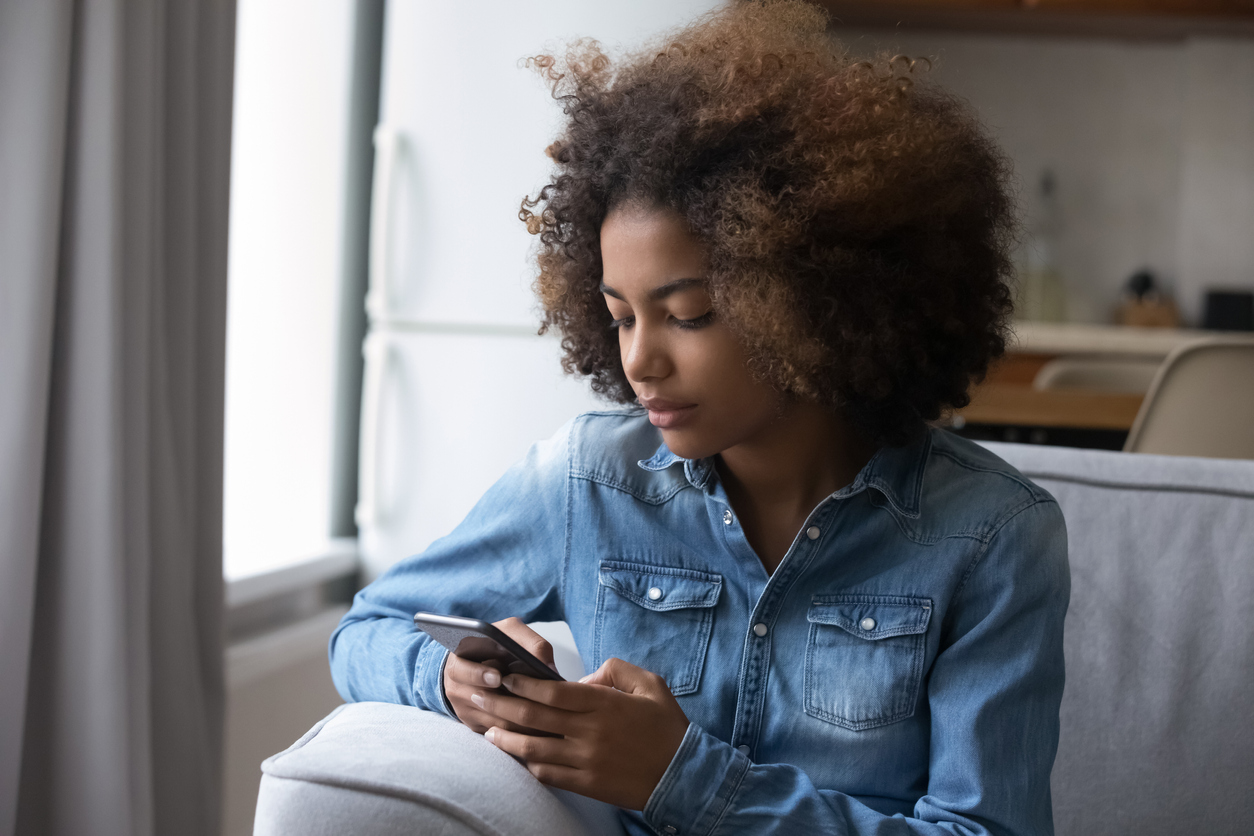 A young person uses a smartphone to go online
